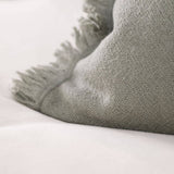 POSZEWKA 60X40 Z WEŁNY Z OZDOBNYM BRZEGIEM OLIWKOWA